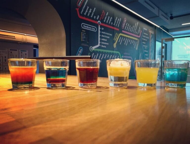Assorted colorful shots served at Haltestelle Shotbar in Innsbruck, Austria, showcasing the bar's creative shot menu inspired by a bus line map, offering over 100 unique shot variations Assorted colorful shots served at Haltestelle Shotbar in Innsbruck, Austria, showcasing the bar's creative shot menu inspired by a bus line map, offering over 100 unique shot variations