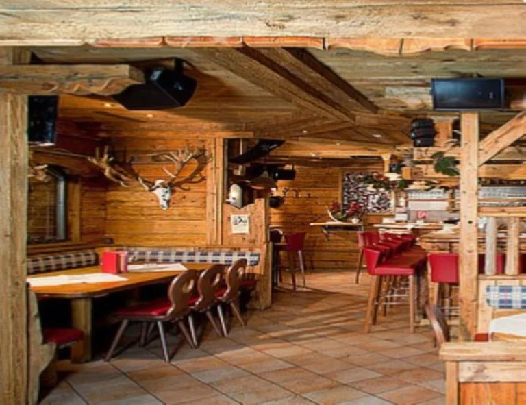 Cozy lounge area of Fuchsloch pub in Sölden, Austria, featuring rustic wooden interiors, intimate seating, and a warm Tyrolean ambiance perfect for après-ski gatherings Cozy lounge area of Fuchsloch pub in Sölden, Austria, featuring rustic wooden interiors, intimate seating, and a warm Tyrolean ambiance perfect for après-ski gatherings