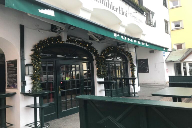 Exterior view of Fünferl bar in Kitzbühel, Austria, showcasing its inviting entrance