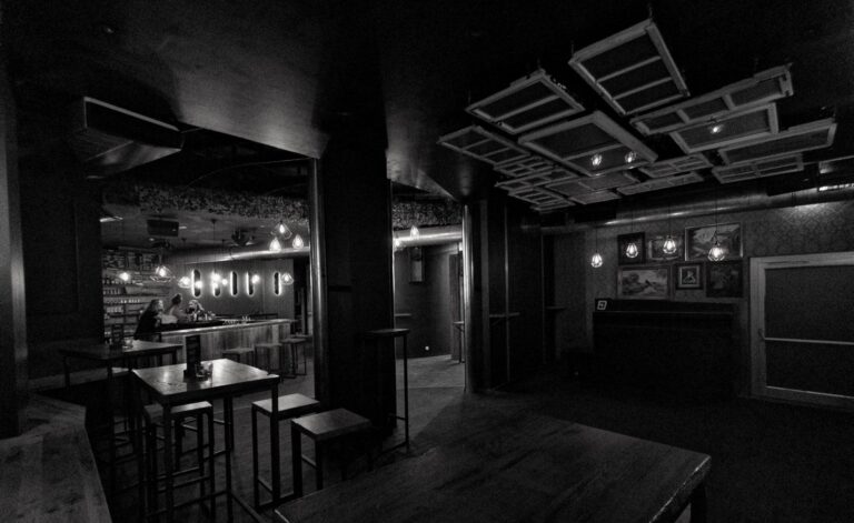 Bar area inside Jimmy's Innsbruck with patrons enjoying a variety of cocktails