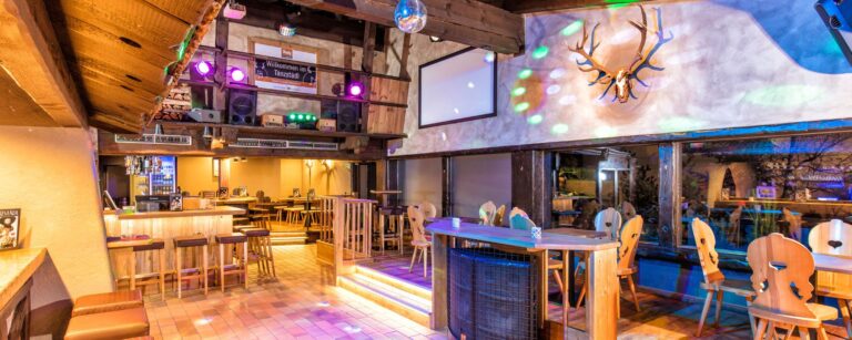 Cozy dining area inside Sölder Stadl with wooden furnishings and traditional decor Cozy dining area inside Sölder Stadl with wooden furnishings and traditional decor