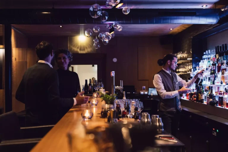 Guests socializing and enjoying drinks at Skybar 2.100 Schöne Aussicht in Hochsölden, Austria, featuring panoramic views of the Ötztal Alps, sophisticated alpine ambiance, and leather seating in a chic rooftop setting Guests socializing and enjoying drinks at Skybar 2.100 Schöne Aussicht in Hochsölden, Austria, featuring panoramic views of the Ötztal Alps, sophisticated alpine ambiance, and leather seating in a chic rooftop setting