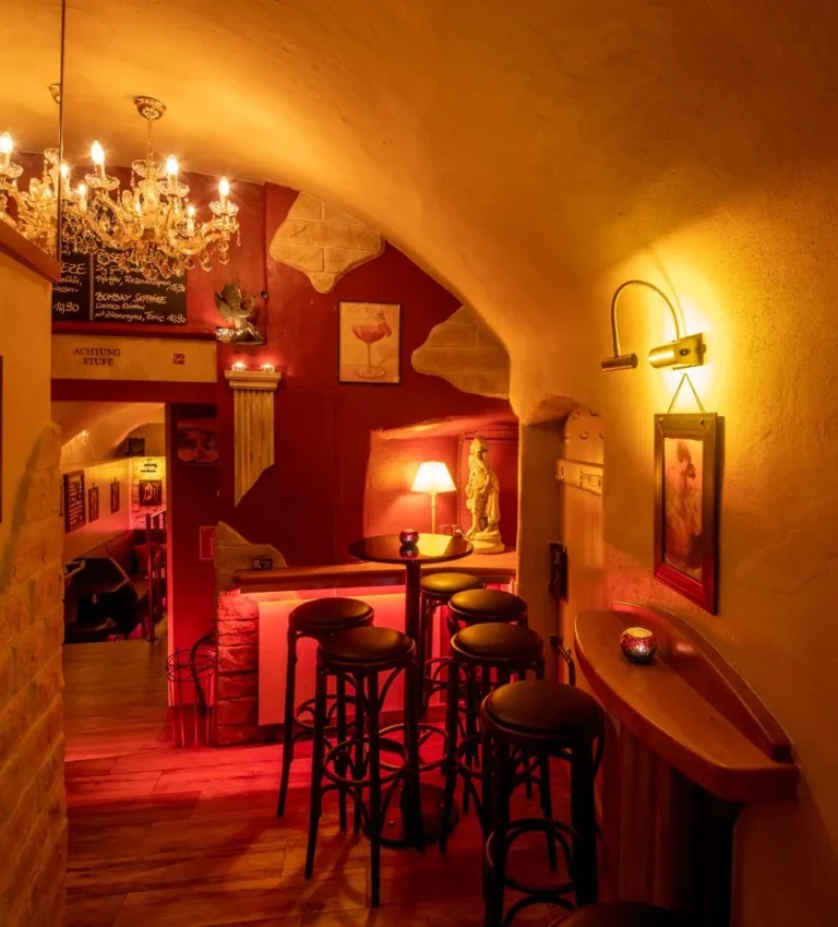 Interior of M+M Cocktailbar in Innsbruck, Austria, featuring a cozy and stylish atmosphere with warm lighting, comfortable seating, and a well-stocked bar, offering a relaxing setting for enjoying a wide variety of cocktails