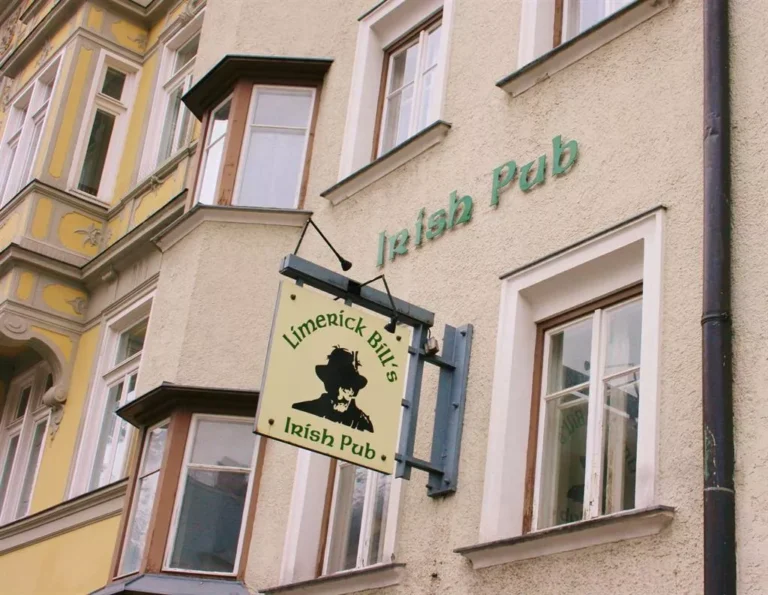 Entrance of Limerick Bill's Irish Pub in Innsbruck, Austria, located at Maria-Theresien-Strasse 9, featuring a traditional Irish pub façade with wooden signage, welcoming patrons into a cozy atmosphere offering Guinness, Kilkenny, and live music