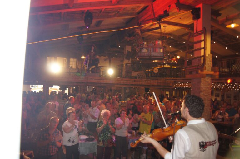 Lively interior of Brück'n Stadl with guests enjoying après-ski festivities