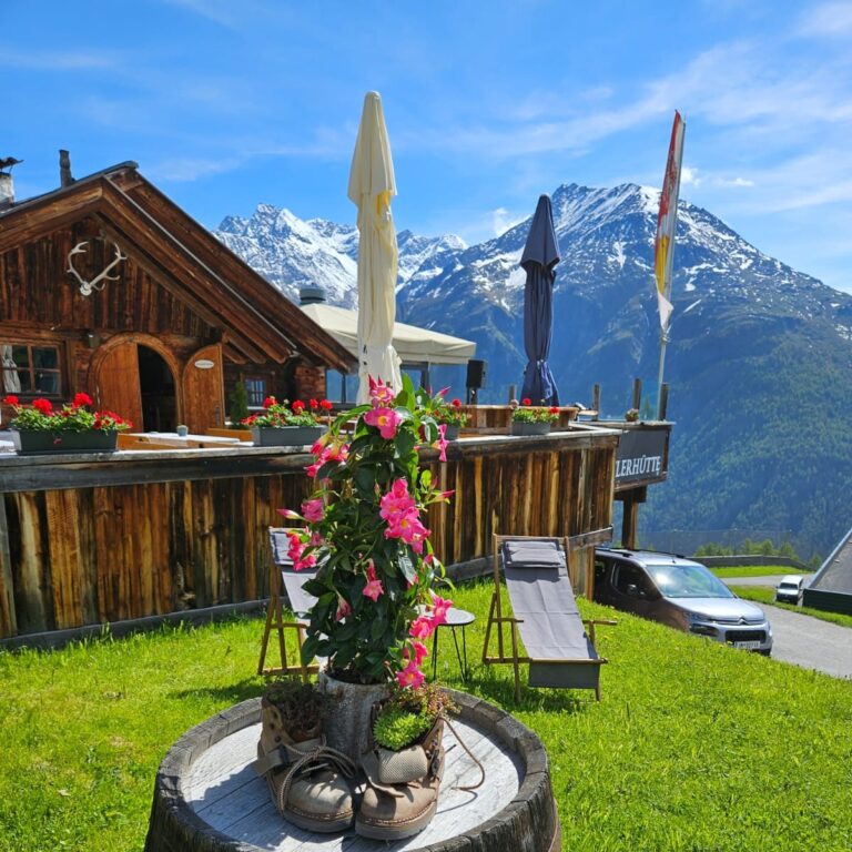 Exterior view of Eugen’s Obstlerhütte, a rustic alpine hut located just below Hochsölden in Sölden, Austria, featuring a spacious sun terrace and traditional Tyrolean architecture